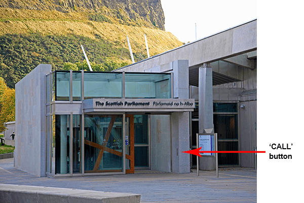 Arrow pointing at 'Call' button at entrance to Scottish Parliament