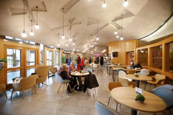 a cafe with people sitting around at different tables