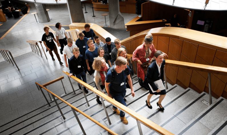 a school group walk up the main staircase at the parliament