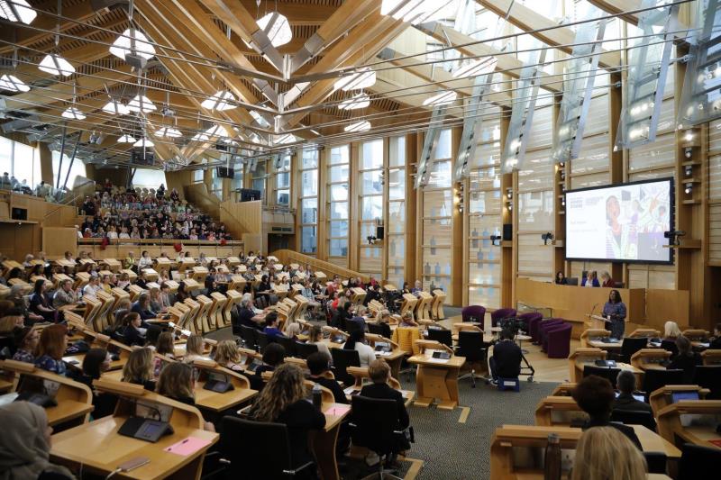 People attending an event in the debating chamber
