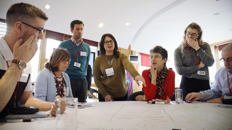 a group of people discussing at a table