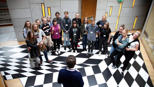 Public tour in the black and white corridor at the Scottish Parliament