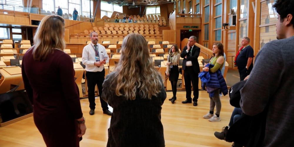 A tour group in the debating chamber