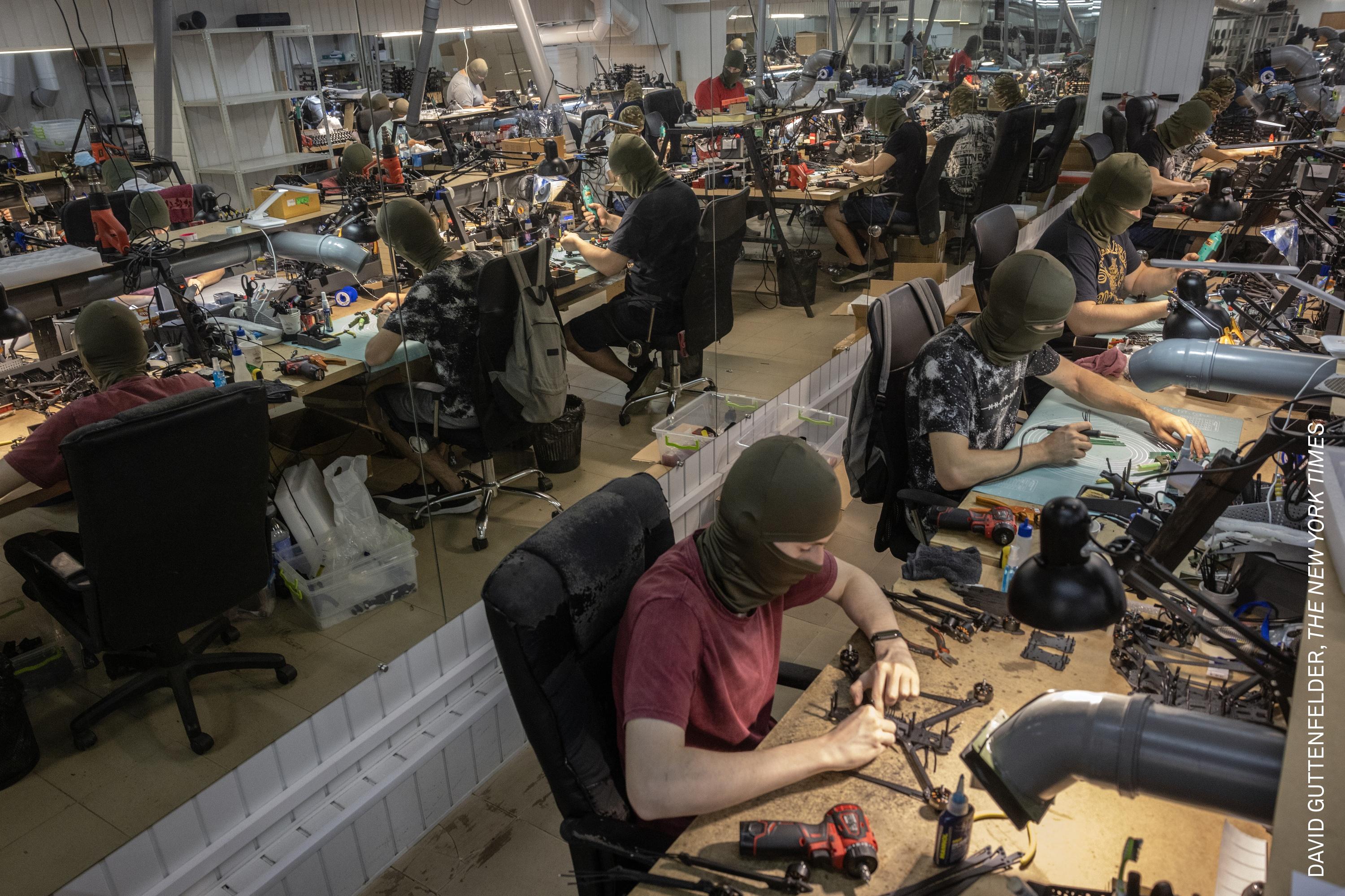 Ukrainian civilians, their identities concealed behind masks, assemble FPV drones in a basement factory in Central Ukraine. Both Ukraine and Russia now manufacture millions of battlefield drones a year.