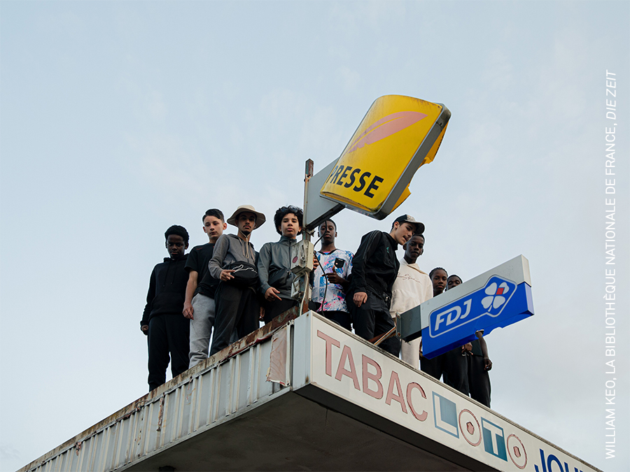 Young men gather on a rooftop in the Briques Rouges, one of the largest social housing projects in Verneuil-sur-Seine, France.