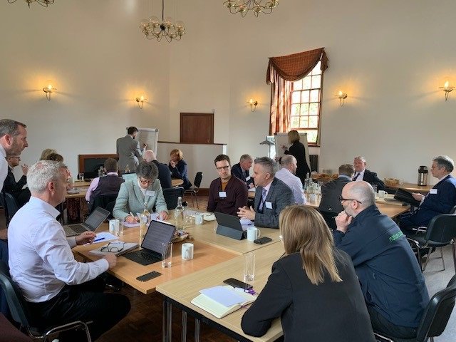 Photograph 1 - Committee members and participants discussing issues around a table at the Dundee engagement event.