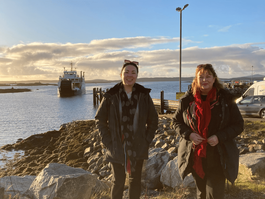 Committee Members wait onshore as a ferry arrives into port.