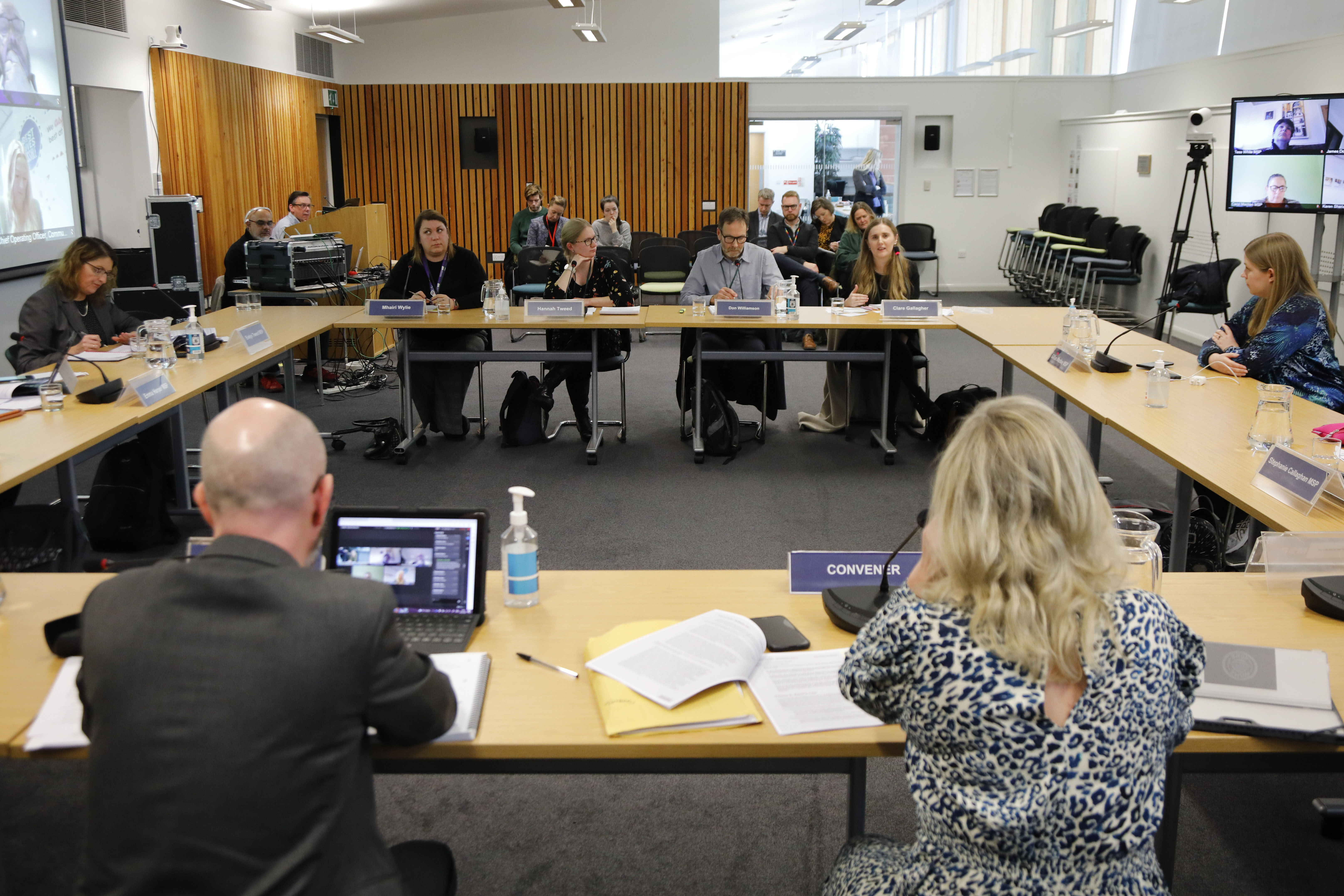 An image of the Committee holding a formal meeting at the William Quarriers Conference Centre in Glasgow