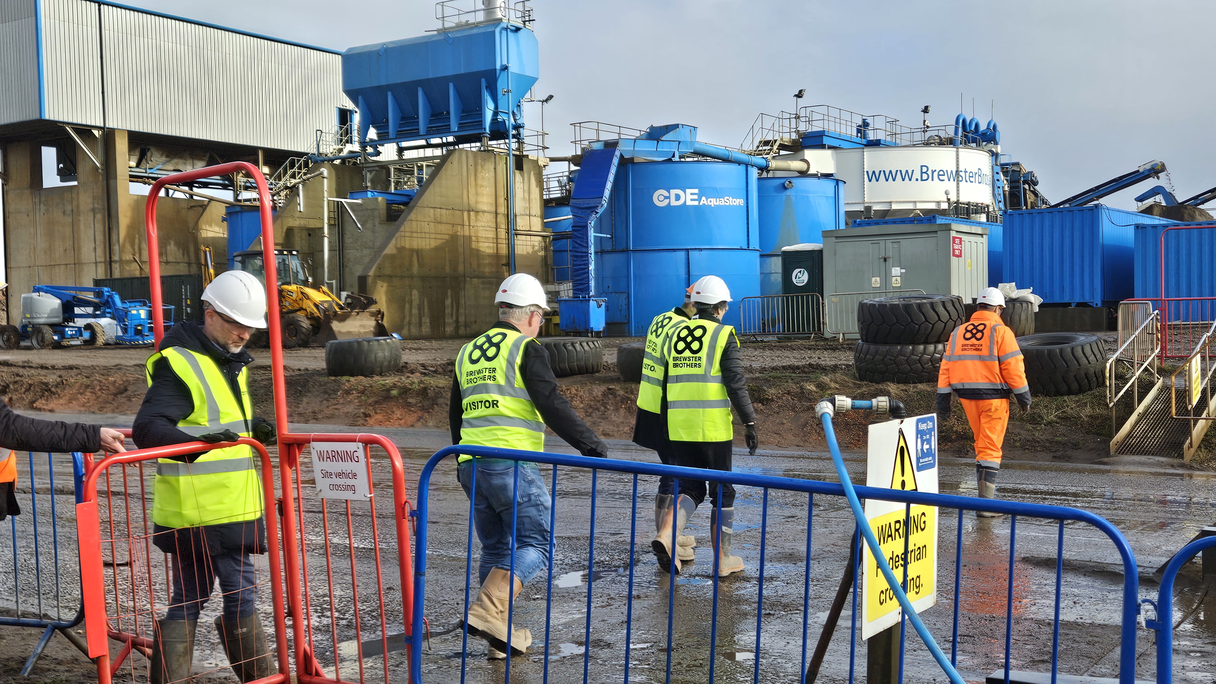 Photograph of Finance and Public Administration Committee Members walking across the site during the fact-finding visit at Brewster Brothers